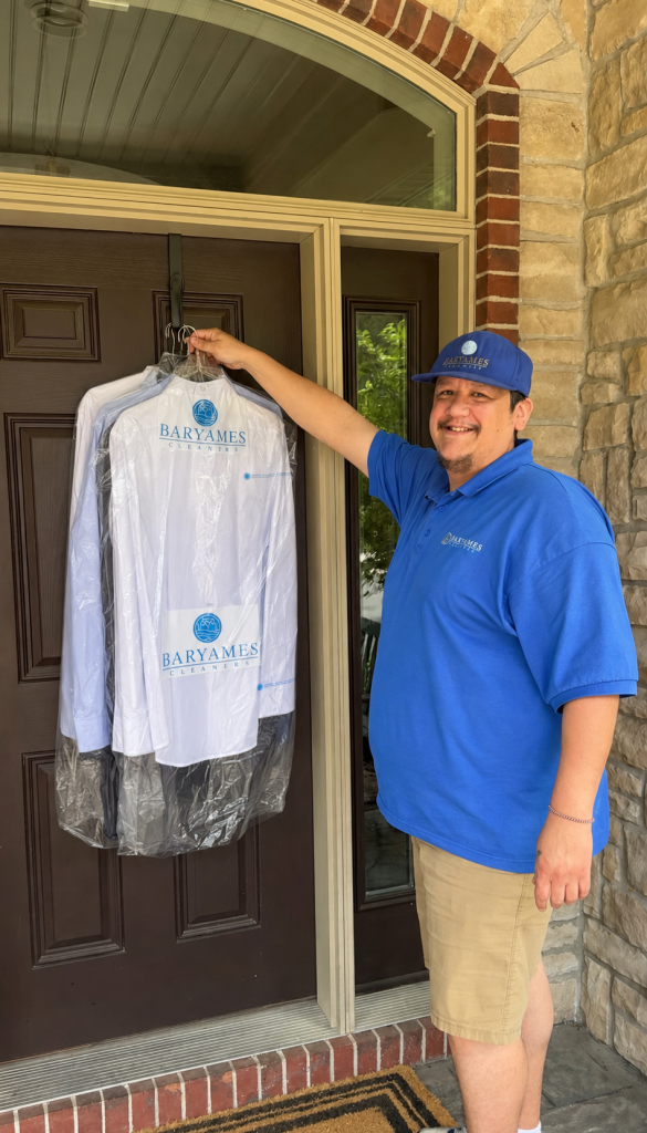 Baryames driver delivering freshly cleaned garments to a customer's door